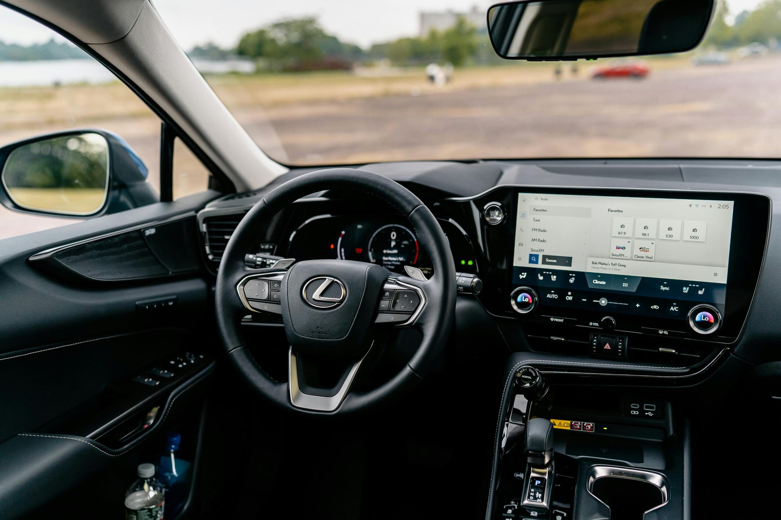 Detailed view of a Lexus car interior featuring a modern touchscreen and steering controls.